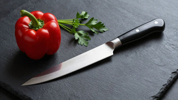 High-end chef's knife with fresh ingredients.