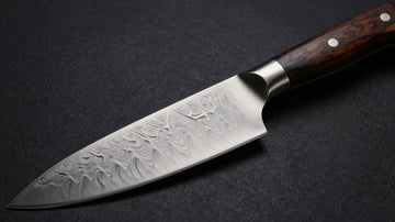 Premium Damascus steel chef's knife with intricate blade patterns.